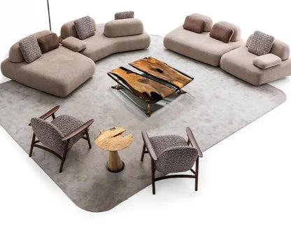 Modern living room with beige sectional sofa, wooden coffee table, and chairs on a gray rug.